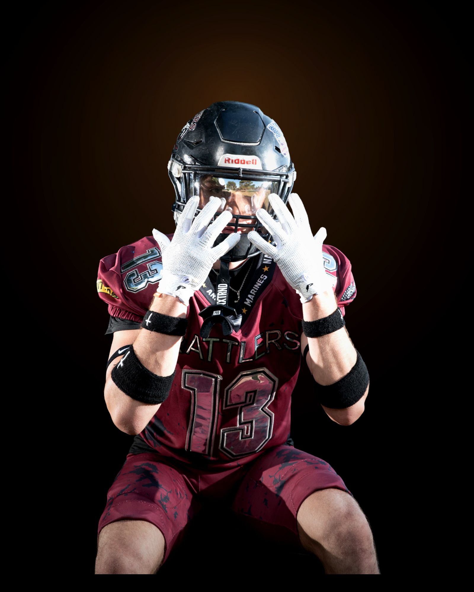 Jack Shepherd seated in a wide stance, both gloved hands framing his helmet visor.