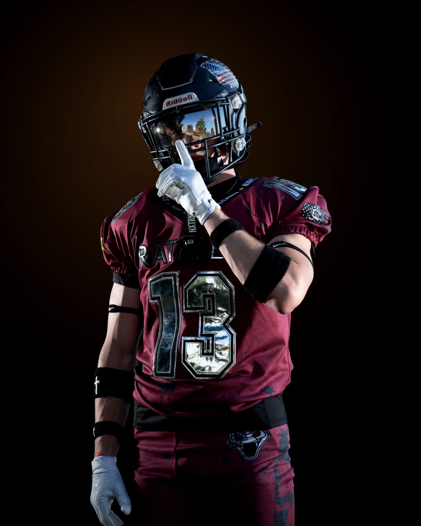 Jack Shepherd with one gloved finger raised to his visor, the number thirteen bright across his jersey.